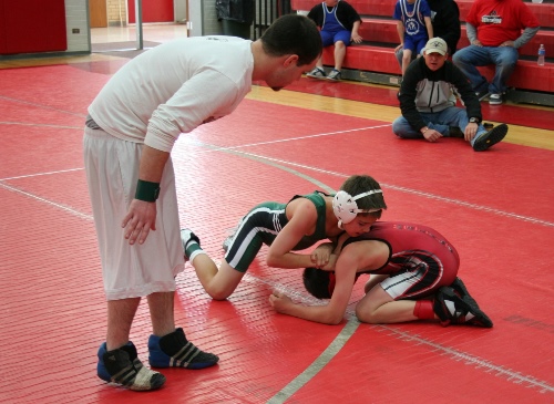 2 boys competing in a wrestling match