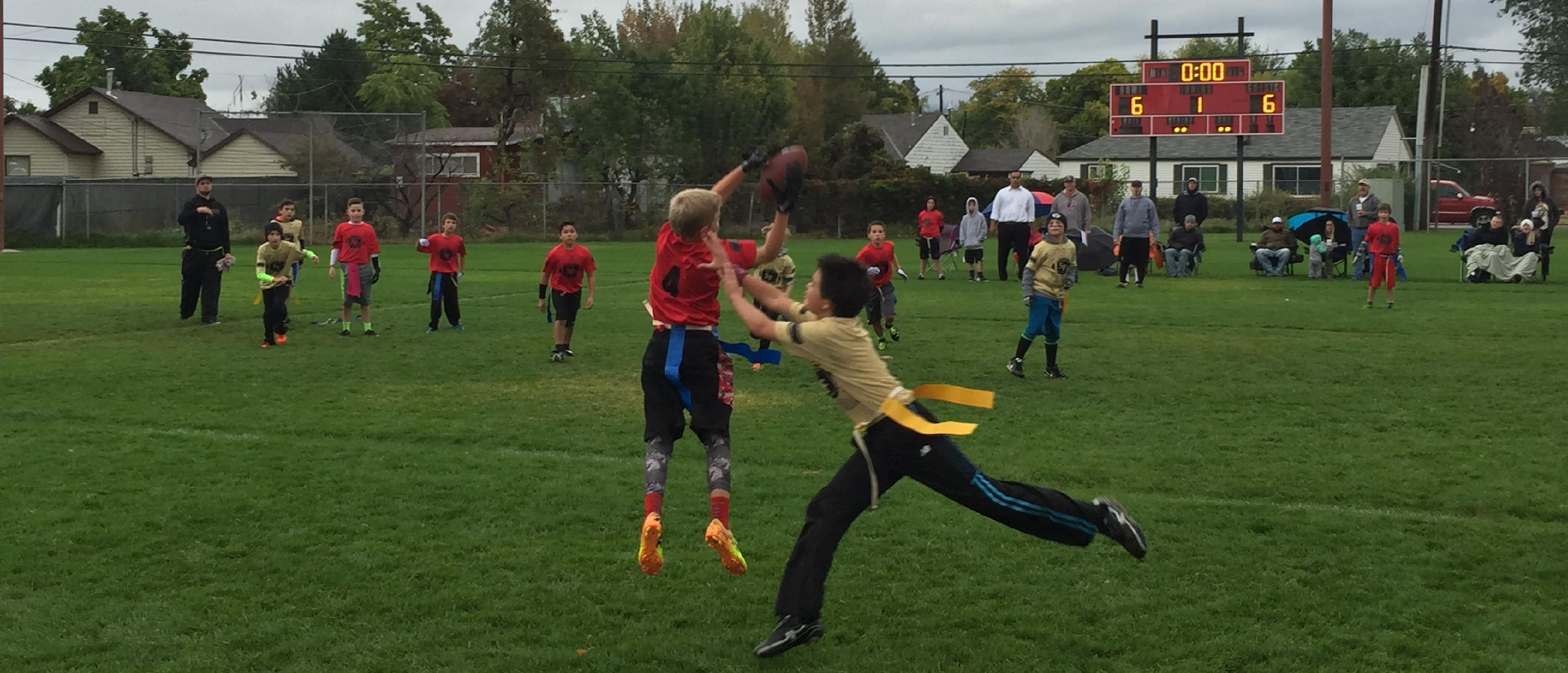 youth participating in a flag football game